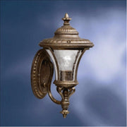 Kichler 9394TZG outdoor wall lantern with a bronze-and-gold frame, clear textured glass and ornate finials