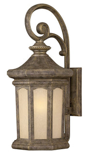 Hinkley Rowe Park wall lantern with a large scroll, broad roof and pale textured glass panels.