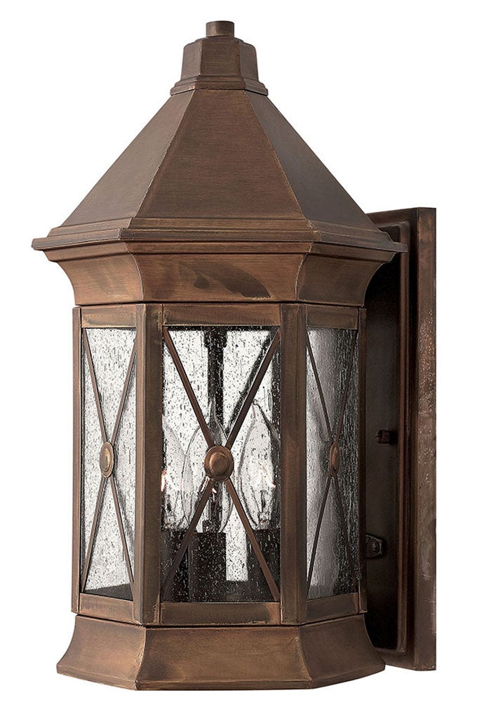 Hinkley Brighton wall lantern with brown-copper-toned frame, textured clear glass, diagonal bars and circular medallions