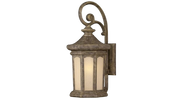 Hinkley Rowe Park 2135PZ bronze wall lantern with a scroll support, layered cap and pale glass panels.