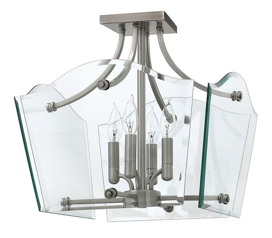 Hinkley Wingate fixture with four candle-style lights, clear curved panels and polished metal framing