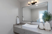 Z-Lite Willow three-light Matte Black vanity light installed above a bathroom mirror