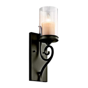 Kichler Lara wall sconce with a clear cylindrical enclosure, curling arm and rectangular backplate
