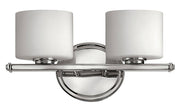 Hinkley Ocho chrome vanity light with two white cylindrical shades, a slim bar and round backplate.