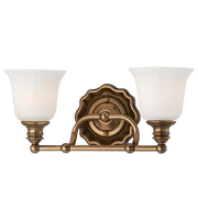 Traditional gold-toned vanity light with curved arms, two flared white shades and a decorative round backplate.