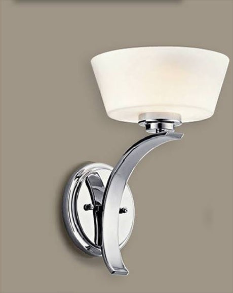 Kichler Rise chrome wall sconce with a pale tapered bowl shade, sweeping crescent arm and round backplate.