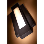 Angled illuminated view of the George Kovacs Insert sconce showing its shallow layered frame