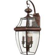 Side view of the Quoizel Newbury hanging lantern showing three candle-style lights behind beveled glass