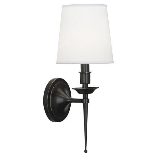 Robert Abbey Cedric Z388 wall sconce with a tapered white shade, dark round backplate and long pointed finial