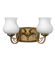 Hinkley Olivia bronze vanity light with scrolling arms, a beaded backplate and two white urn-shaped shades.