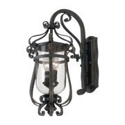 Kalco Hartford wall lantern with a scrolling bracket and clear hurricane shade