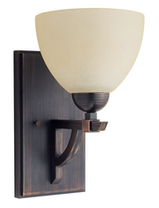 Key West wall sconce with a pale Butterscotch bowl shade, curved bronze bracket and rectangular backplate.