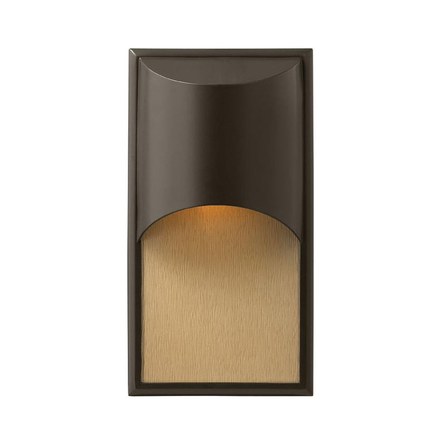 Hinkley Cascade wall sconce with a curved bronze shield layered over an amber textured rectangular panel