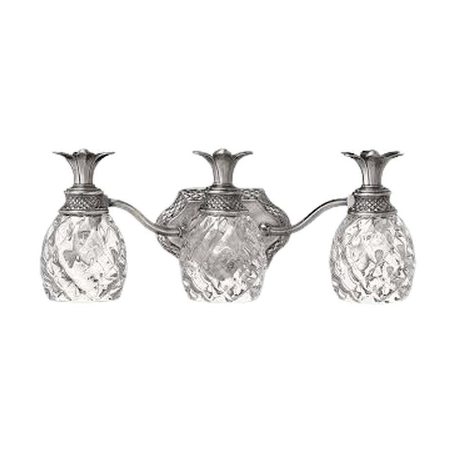 Hinkley Plantation polished antique nickel vanity light showing textured pineapple glass and leaf crowns.