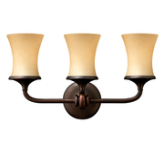 Hinkley Thistledown vanity light with three warm Amber Linen shades and a curved Victorian Bronze frame