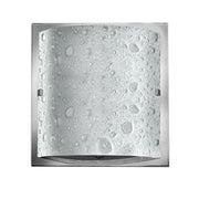 Front view of the Daphne wall sconce and its textured glass panel