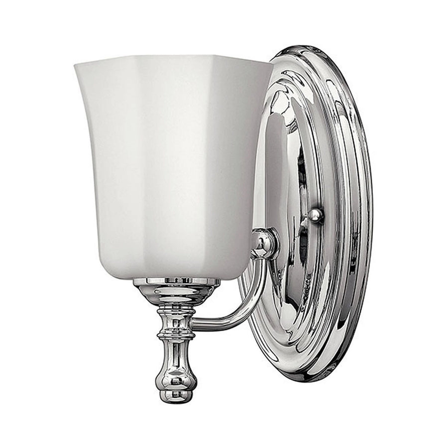 Hinkley Shelly chrome wall sconce with an upward pale shade, curved arm and ornamental oval backplate