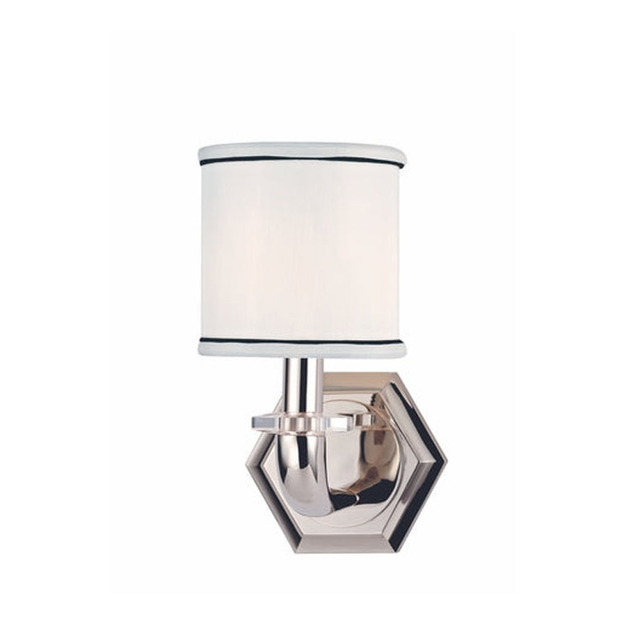 Detailed view of the Rock Hill wall sconce's black-trimmed shade, curved nickel arm and layered hexagonal backplate.