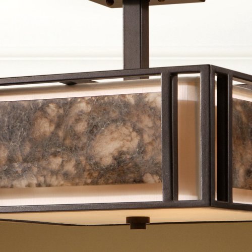 Uttermost Quarry detail showing dark rectangular framing, mottled panels, ivory shade and short ceiling stem