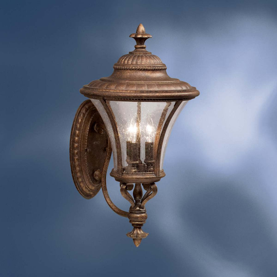 Kichler 9396TZG outdoor wall lantern with candle-style lights, textured glass and bronze-and-gold detailing