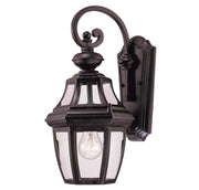 Angled view of the Endorado lantern's ornate scroll arm and layered backplate