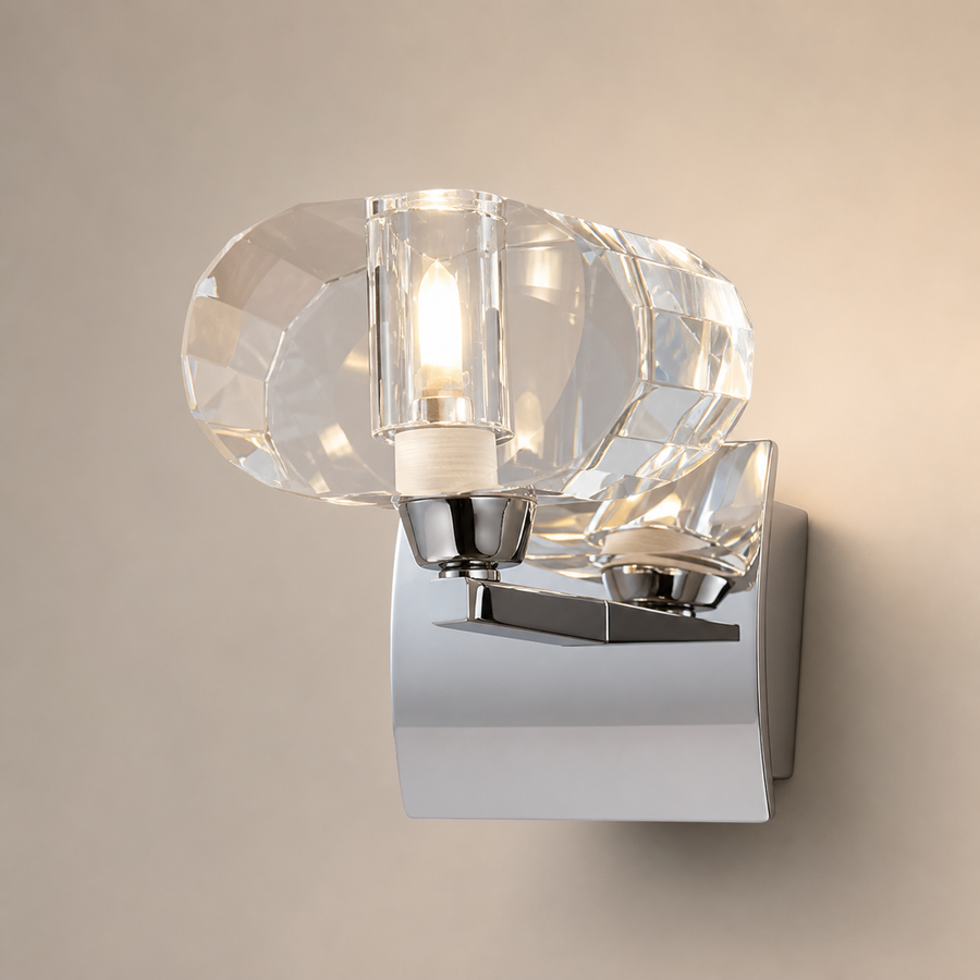 Mantra Alfa wall light with a clear faceted shade and a bowed chrome backplate