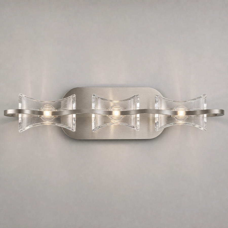 Mantra Krom wall light with three clear curved panels and a satin nickel wave-shaped band.
