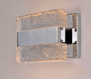 Front-angle view of the Maxim Ice wall light with illuminated textured clear blocks and a reflective centre.