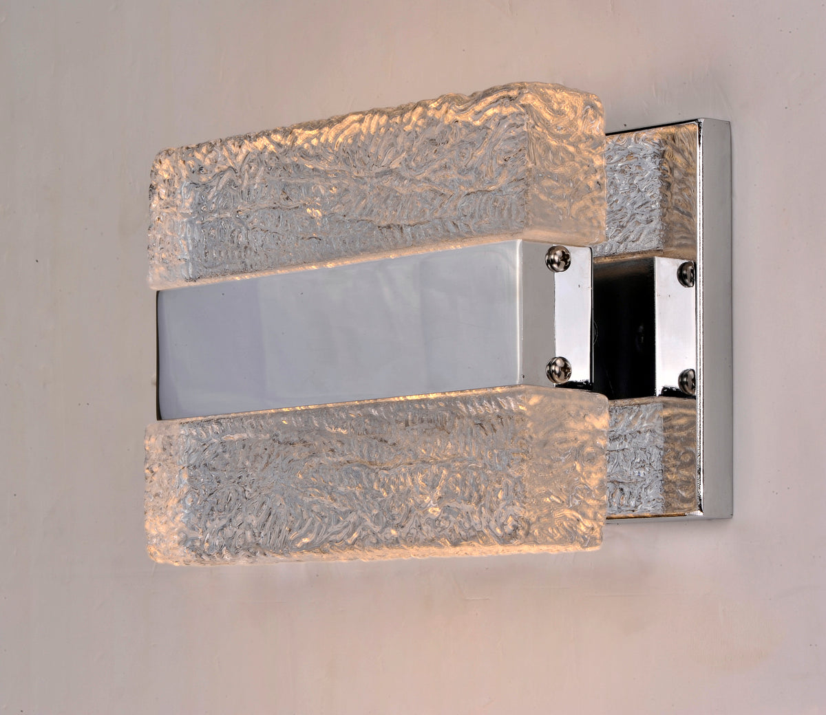 Front-angle view of the Maxim Ice wall light with illuminated textured clear blocks and a reflective centre.