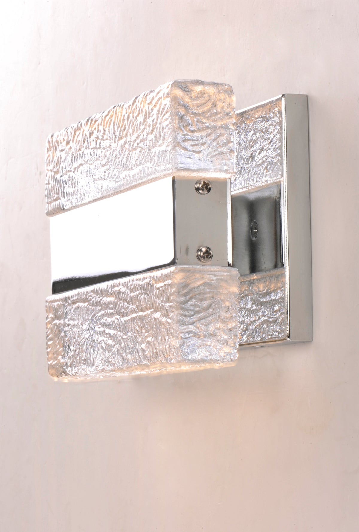 Side view of the Maxim Ice wall light with paired textured blocks and a bright reflective frame.