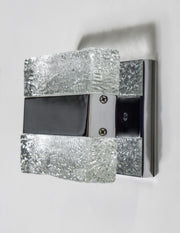 Unlit Maxim Ice wall light showing colourless textured blocks and reflective metal trim.