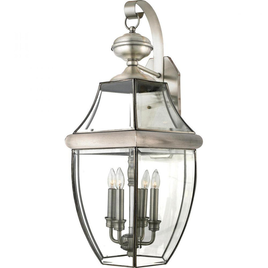 Quoizel Newbury NY8339P pewter wall lantern with a curled support arm, clear glass enclosure and four visible candle lamps