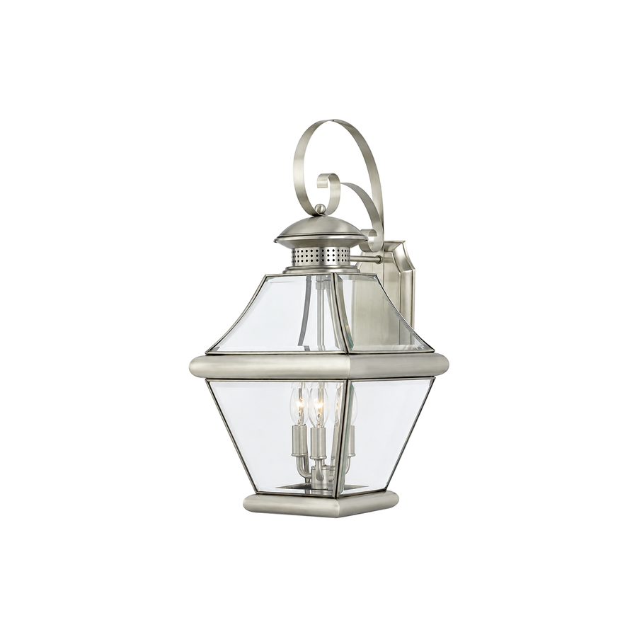 Quoizel Rutledge pewter wall lantern with a curled support, clear panels and an ornamental roof