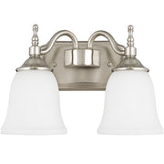 Quoizel Tritan brushed nickel vanity with two downward white bell shades and curved arms.