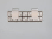 Front view of Quoizel Vetreo Metallica two-shade vanity and its framed square-tile backplate.