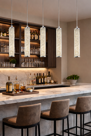 Jazz crystal pendant lit with warm white LED light above a bar counter