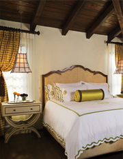 Left Bank lattice pendants beside a bed in a room with a timber ceiling