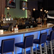 WAC Genesis MP-LED311 brushed nickel LED pendants installed in a row over a bar