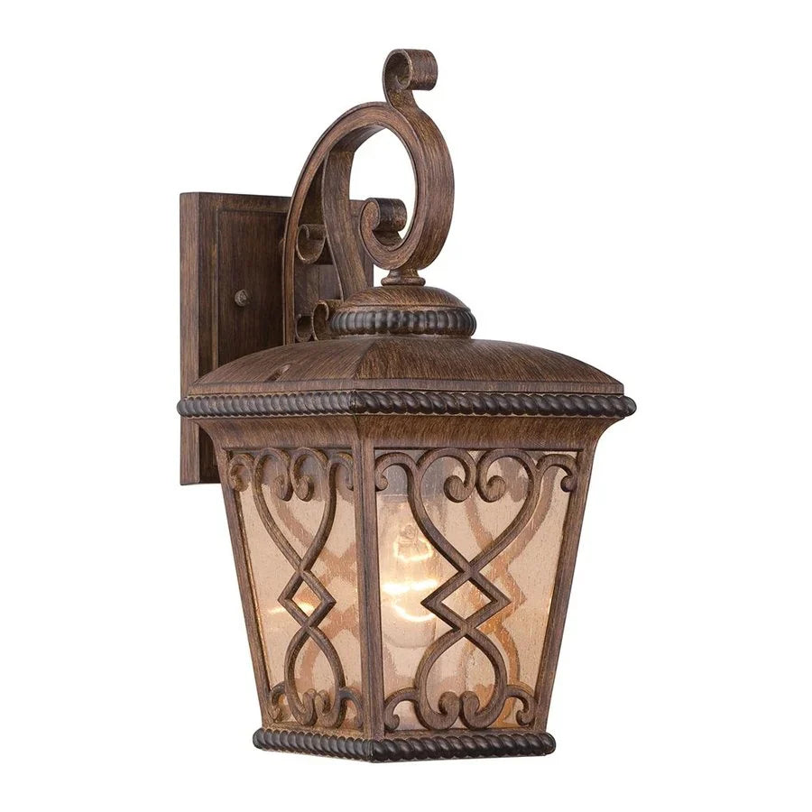 Quoizel Fort Quinn wall lantern with Antique Brown scrollwork and amber glass