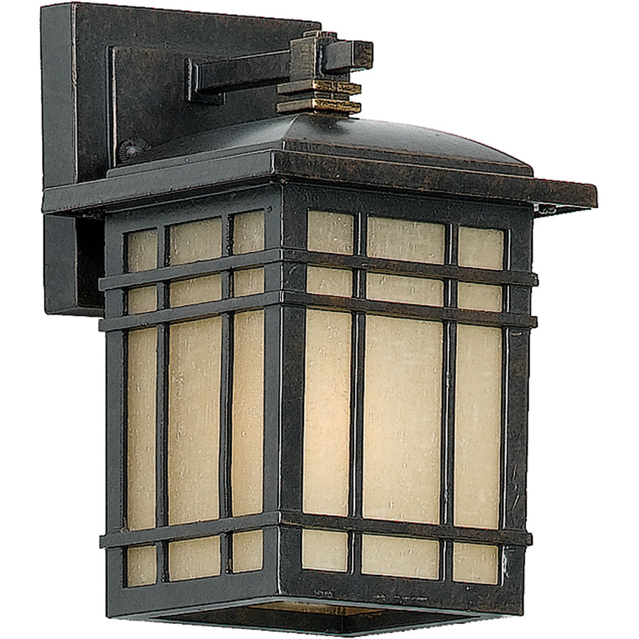Quoizel Hillcrest Imperial Bronze wall lantern with a broad roof and rectangular grid over pale glass.